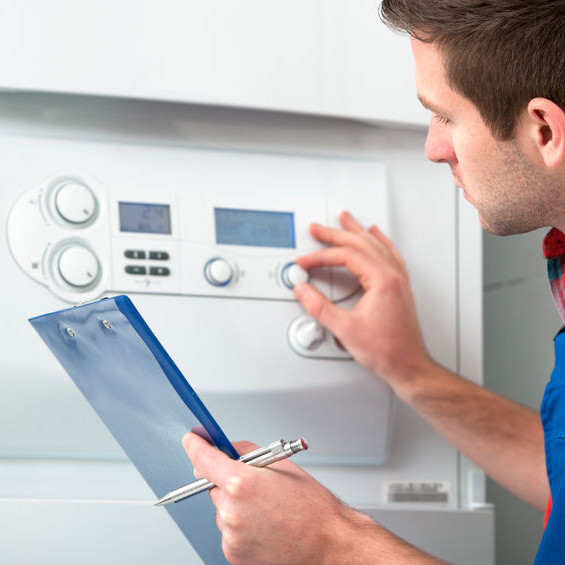 A man examining a thermostat.