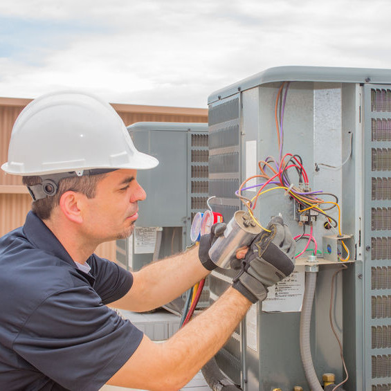 An HVAC tech with a hardhat.